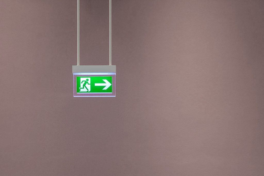 fire escape sign pointing to text